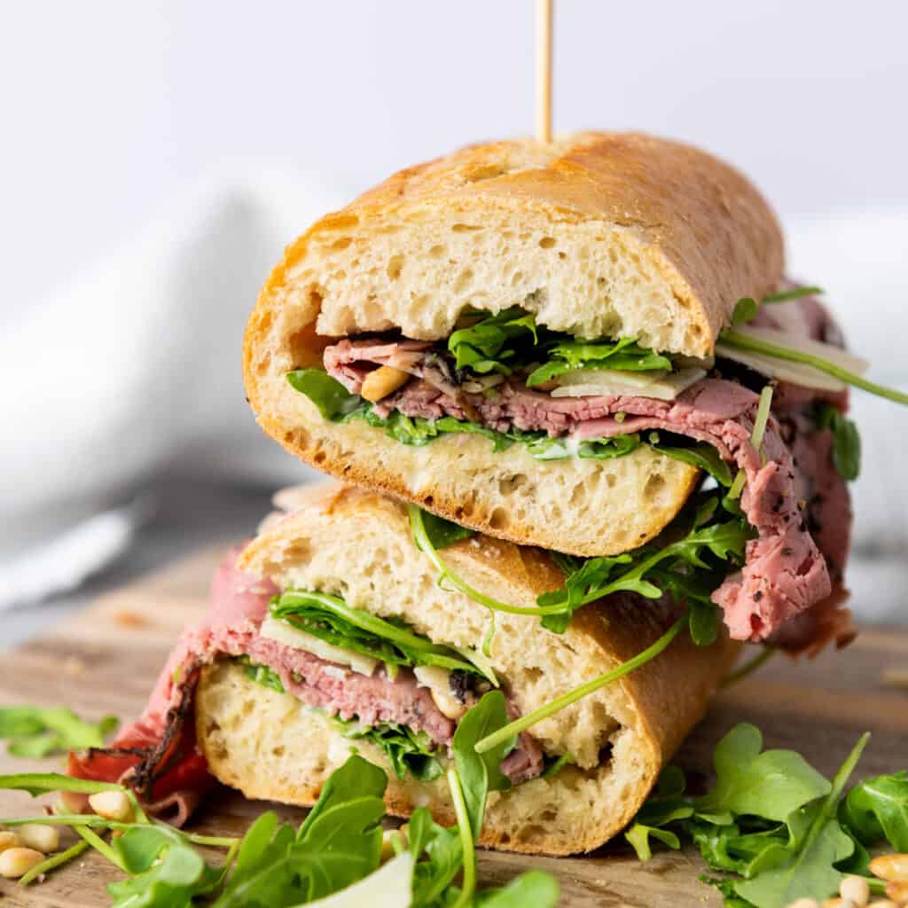 two halves of a roast beef sandwich stacked