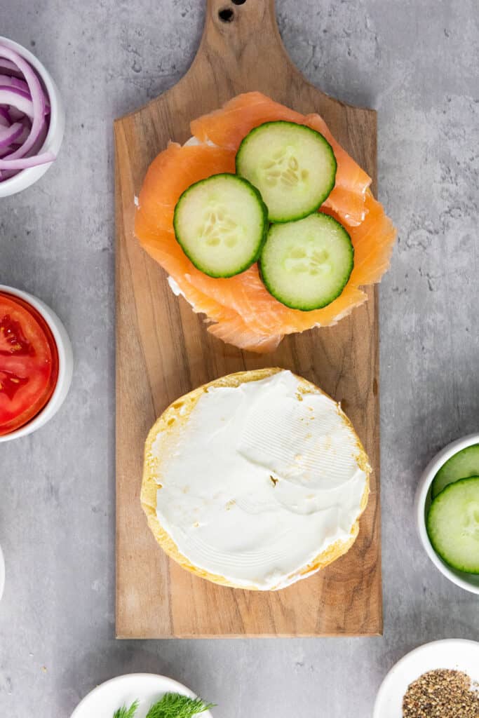 smoked salmon, cucumbers, and cream cheese on bagel