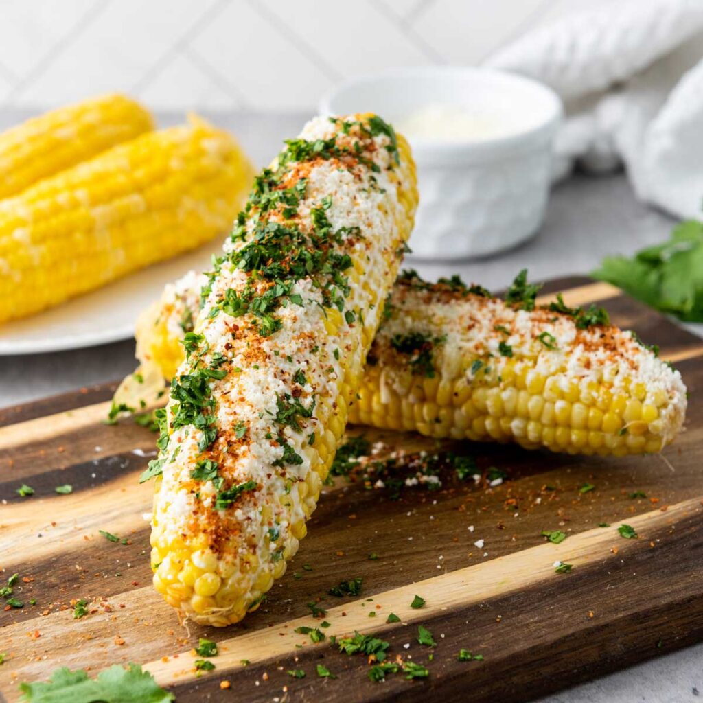 Mexican street corn cobs on cutting board