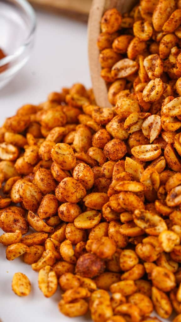 close up of spicy peanuts spilling from bowl