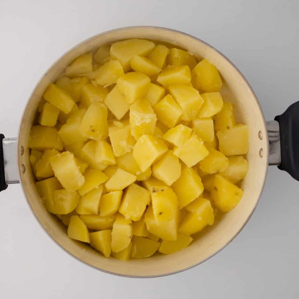 boiled chopped potatoes in pot