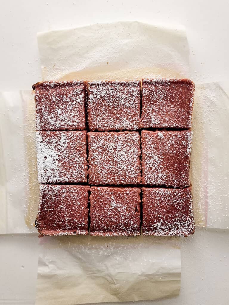 raspberry lemon bars topped with powdered sugar