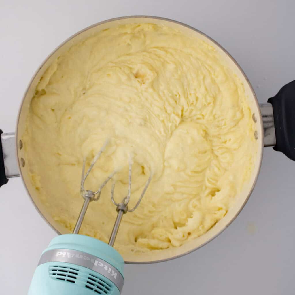 whipped potatoes with mixer in pot
