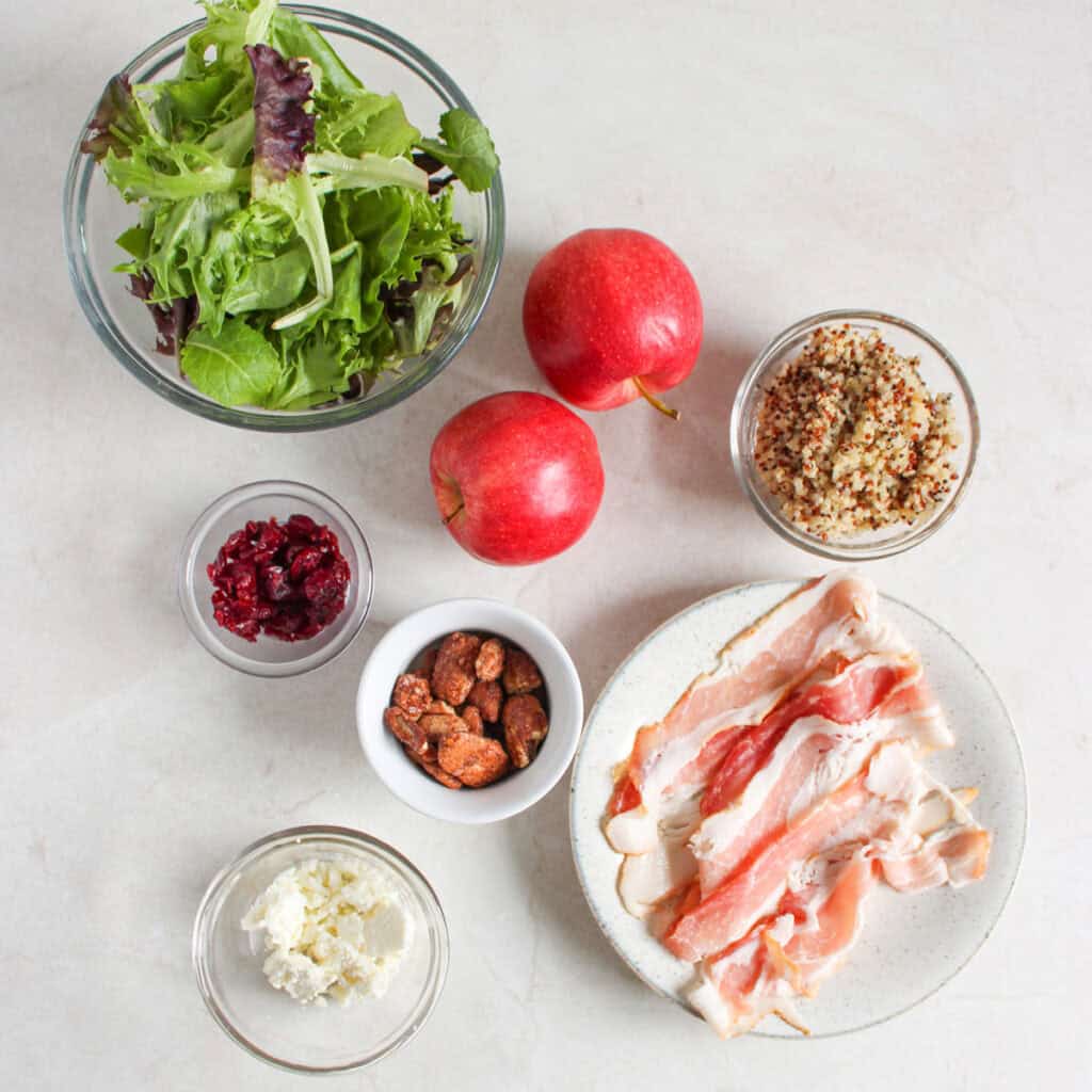 apple bacon salad ingredients in bowls on counter