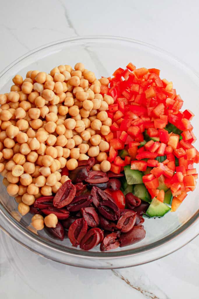 chickpeas, peppers, and olives in glass bowl