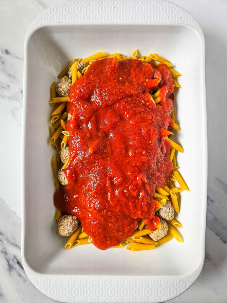 meatballs and noodles with sauce in casserole dish