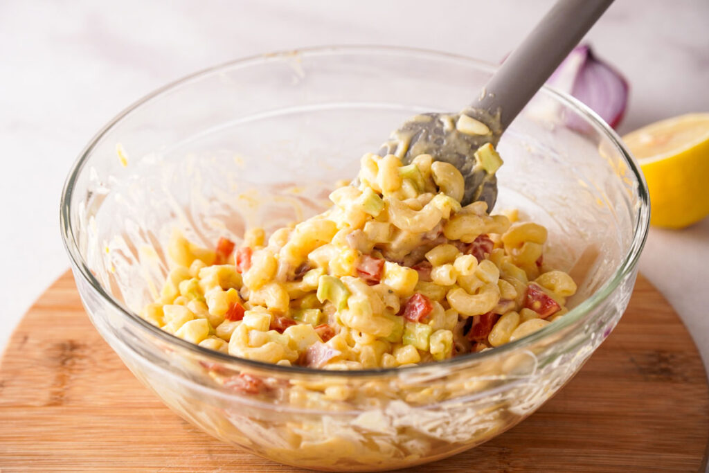 stirring southern macaroni salad