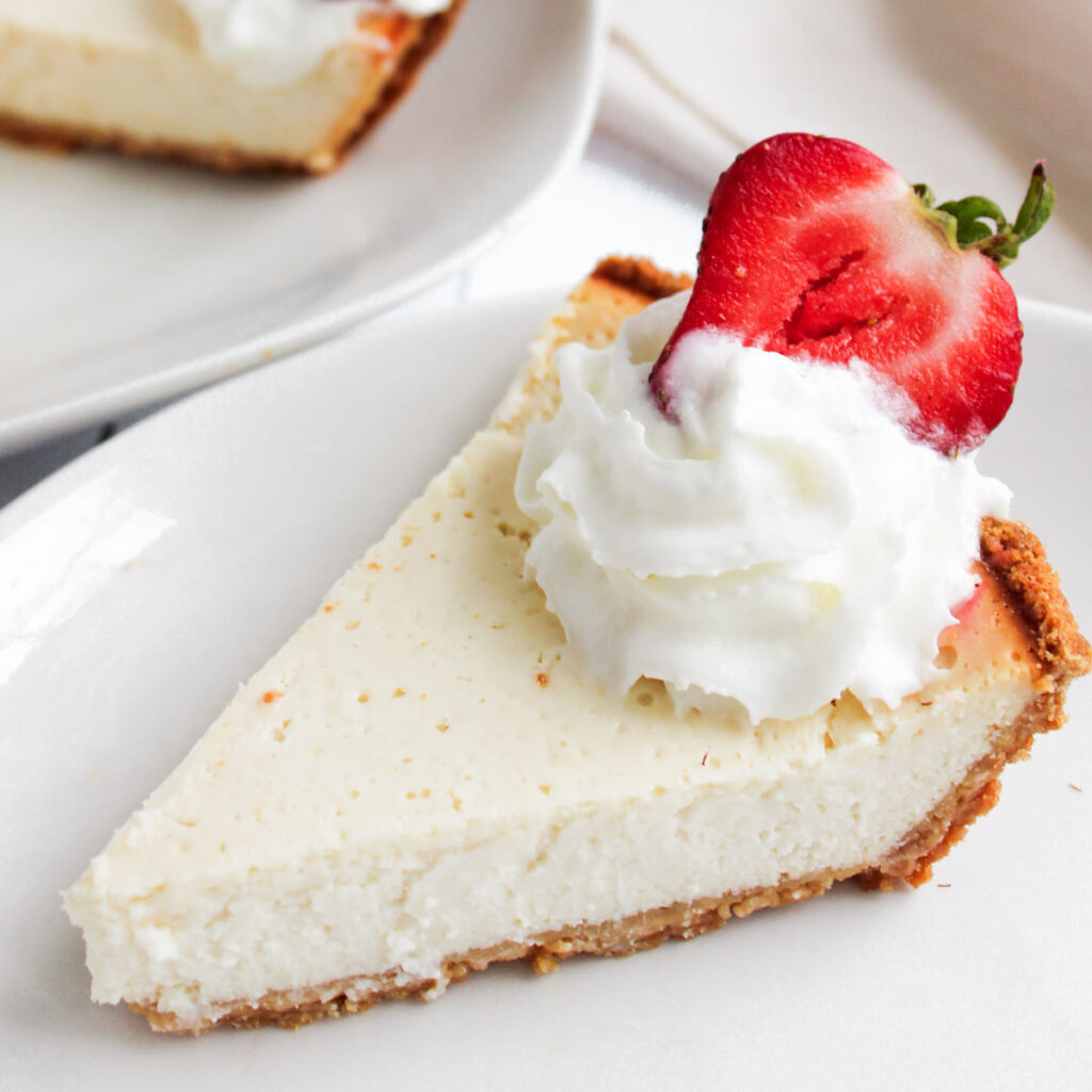 slice of Greek yogurt cheesecake with whipped cream and strawberry