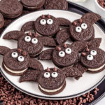 Oreo bats on white plate with mini chocolate chips surrounding