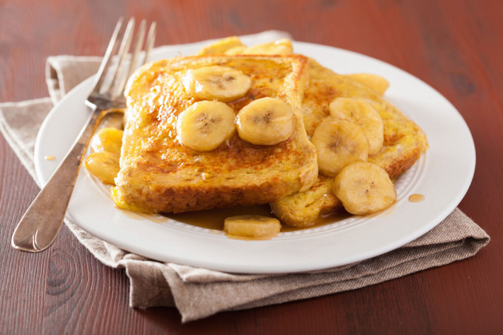 caramelized bananas on french toast on white plate