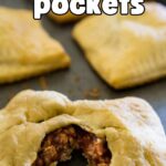 sloppy joe pockets on baking sheet with one cut open