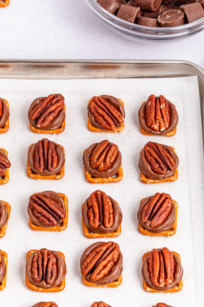 pecan pretzel turtles on baking sheet