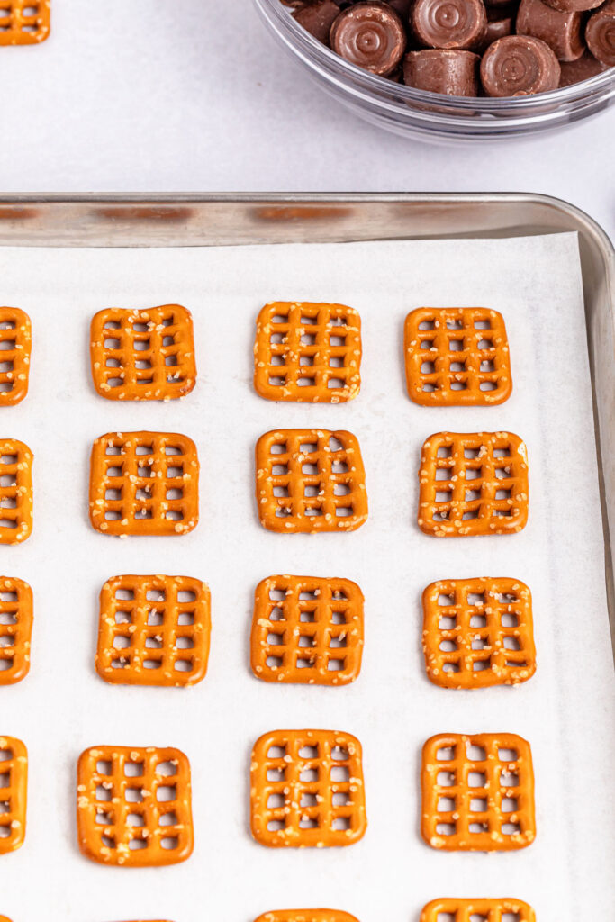 pretzels on parchment paper lined baking sheet