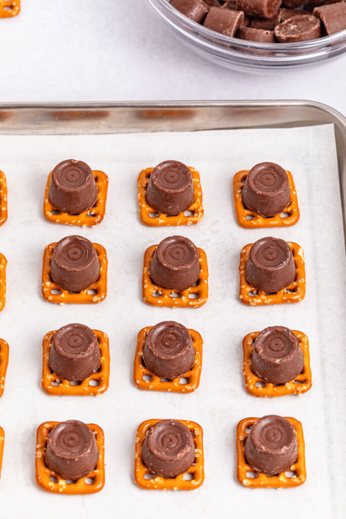pretzels with rolos on top on baking sheet