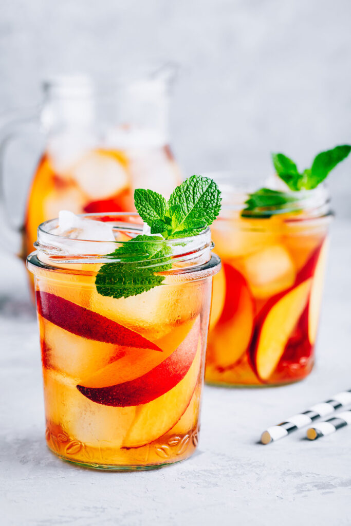 two mason jars of peach iced tea