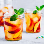 two mason jars of peach iced tea