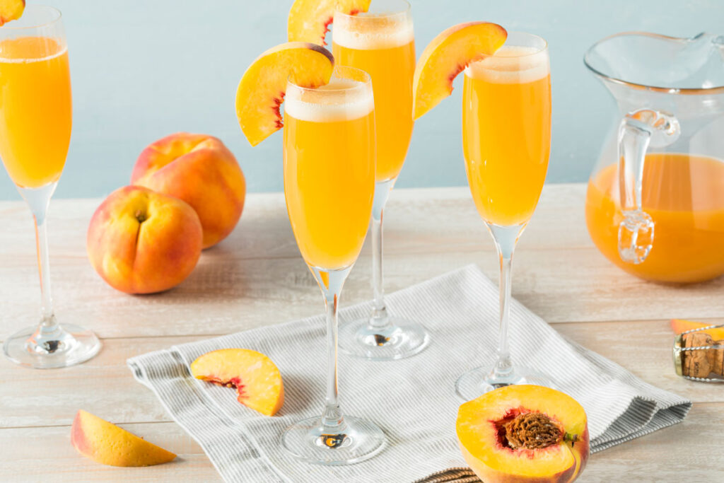 bellini cocktails with peaches and pitcher