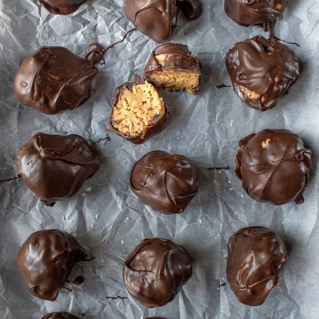 chocolate peanut butter balls on parchment paper