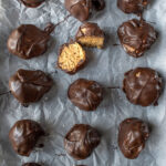 chocolate peanut butter balls on parchment paper