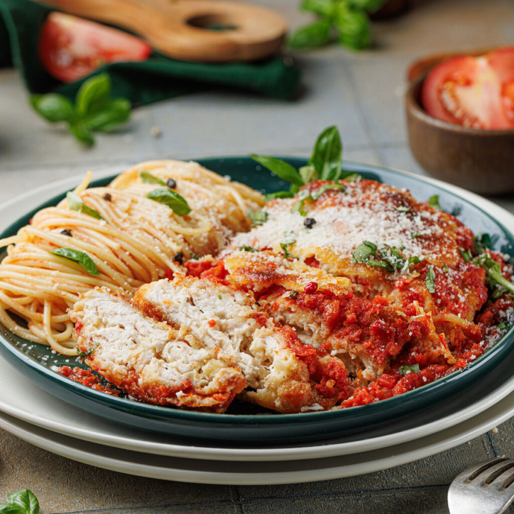chicken parmesan and spaghetti on blue plate