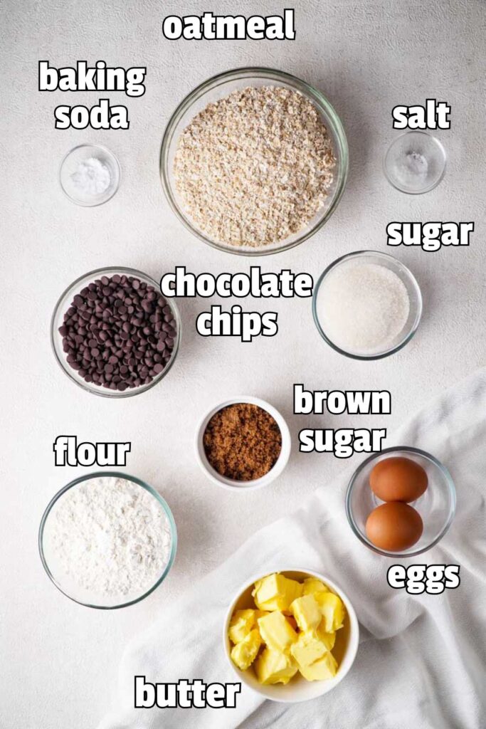 labeled photo of chocolate chip oatmeal cookie ingredients in bowls on countertop