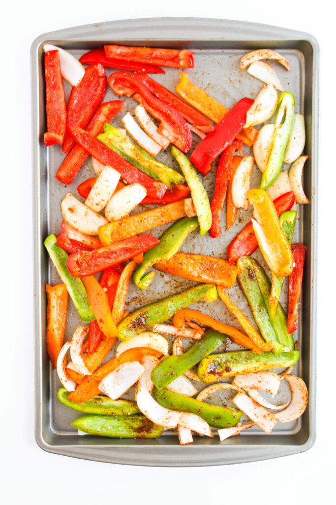 sheet pan with roasted sliced peppers and onions
