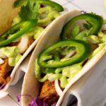 two blackened fish tacos with recipe name overlay