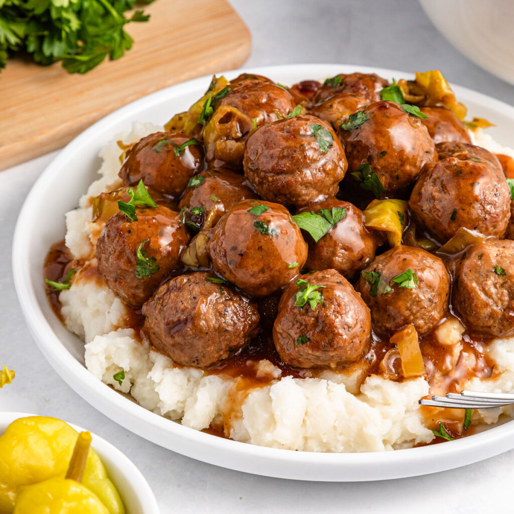 mississippi meatballs over mashed potatoes on plate