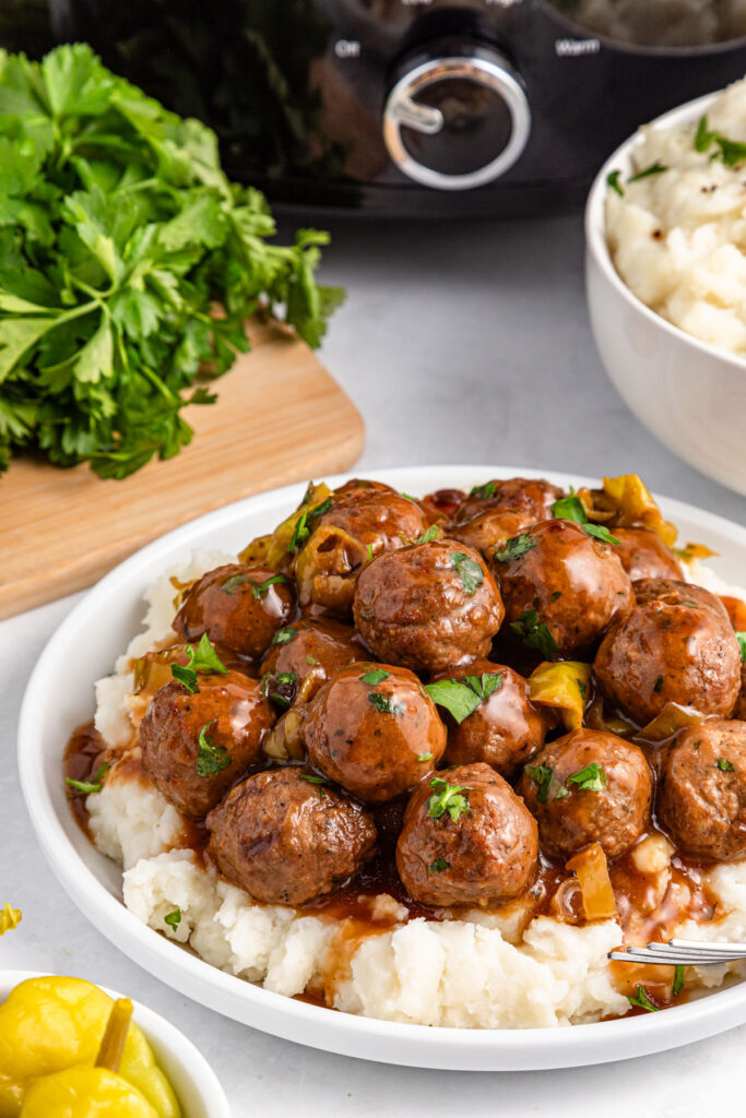 mississippi meatballs over mashed potatoes on plate