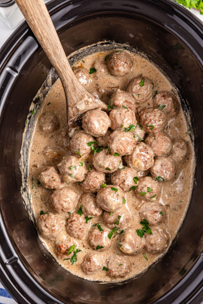 wooden spoon in slow cooker swedish meatballs