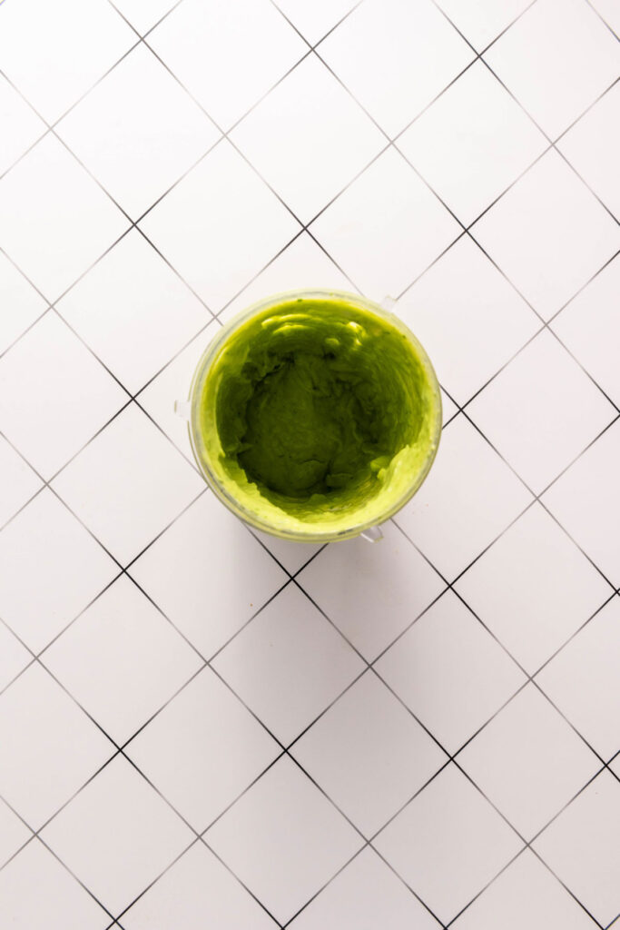 overhead view of avocado sauce in food processor