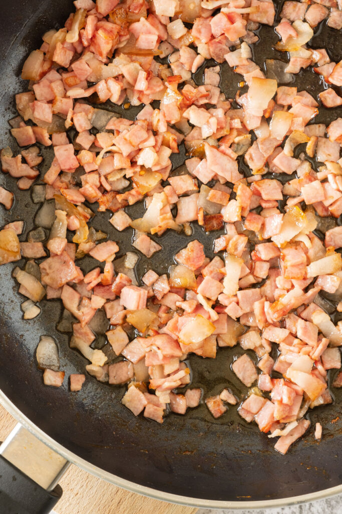 cooking chopped bacon in pan
