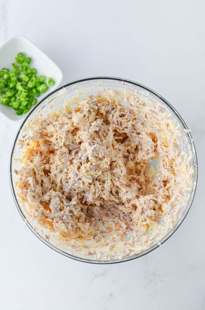 mixing reuben dip in glass bowl