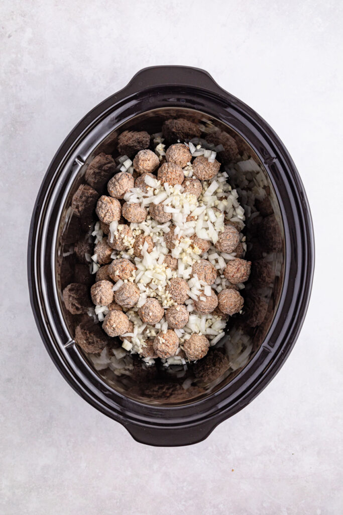 meatballs and diced onion in crock pot