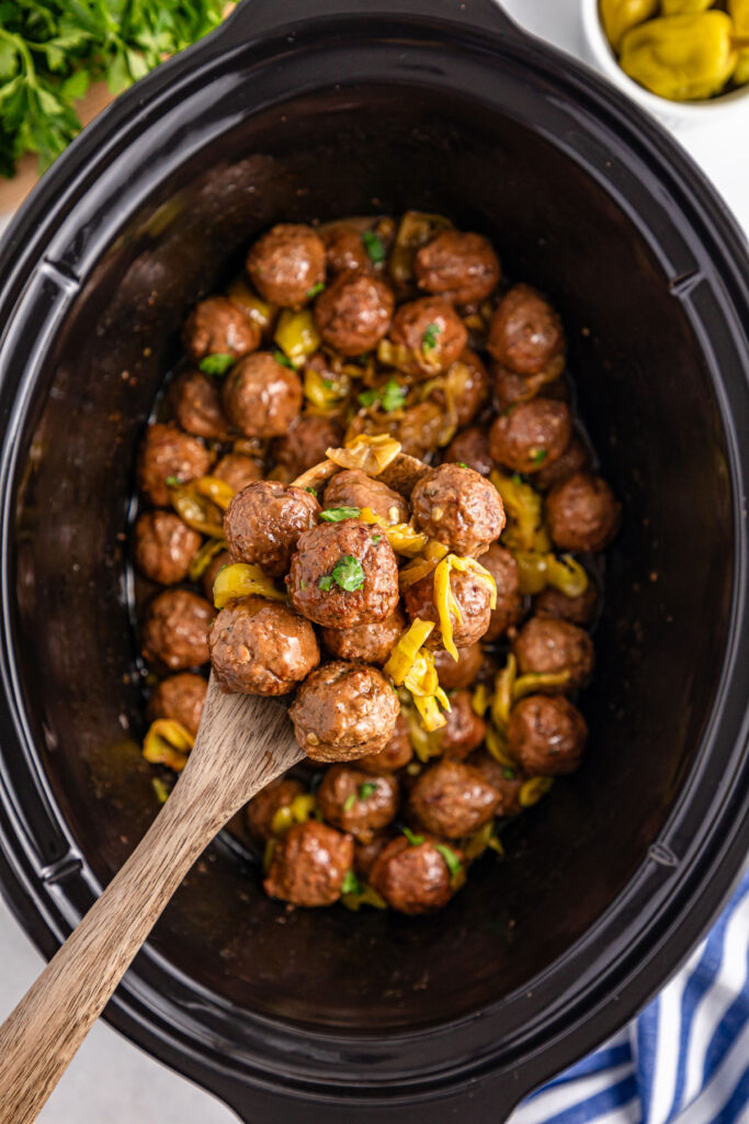 spoon with mississippi meatballs over crock pot