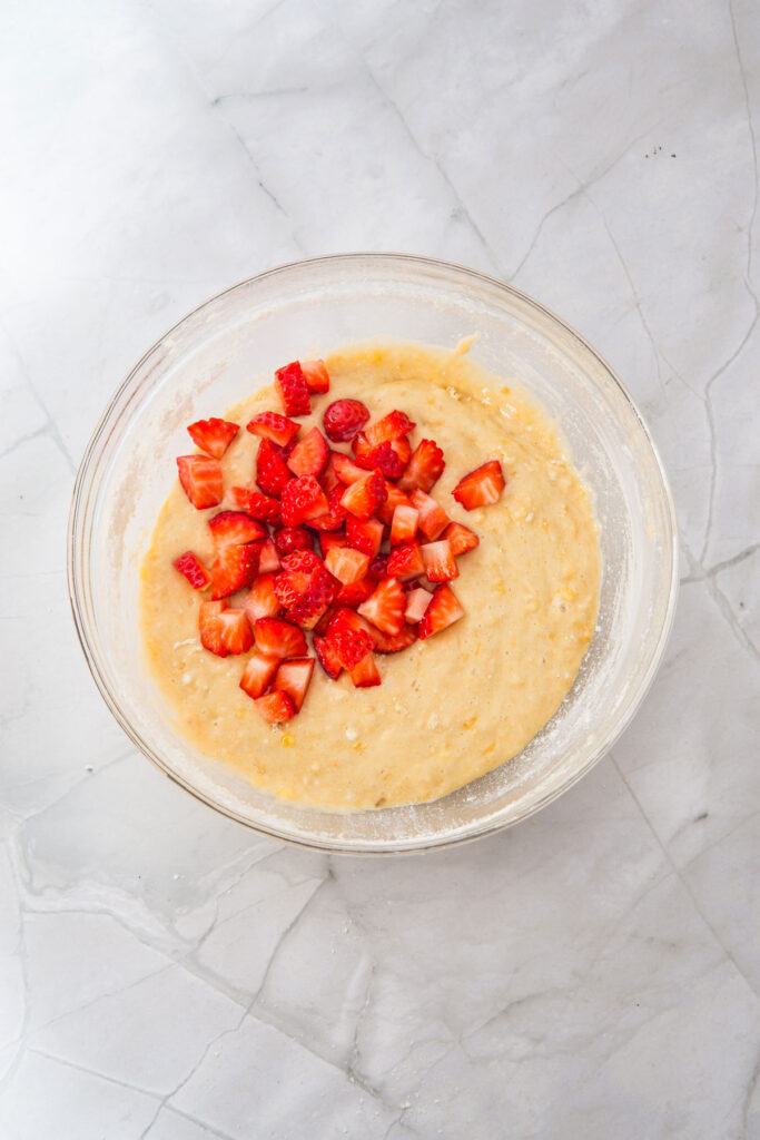 strawberry banana muffin batter with chopped strawberries on top