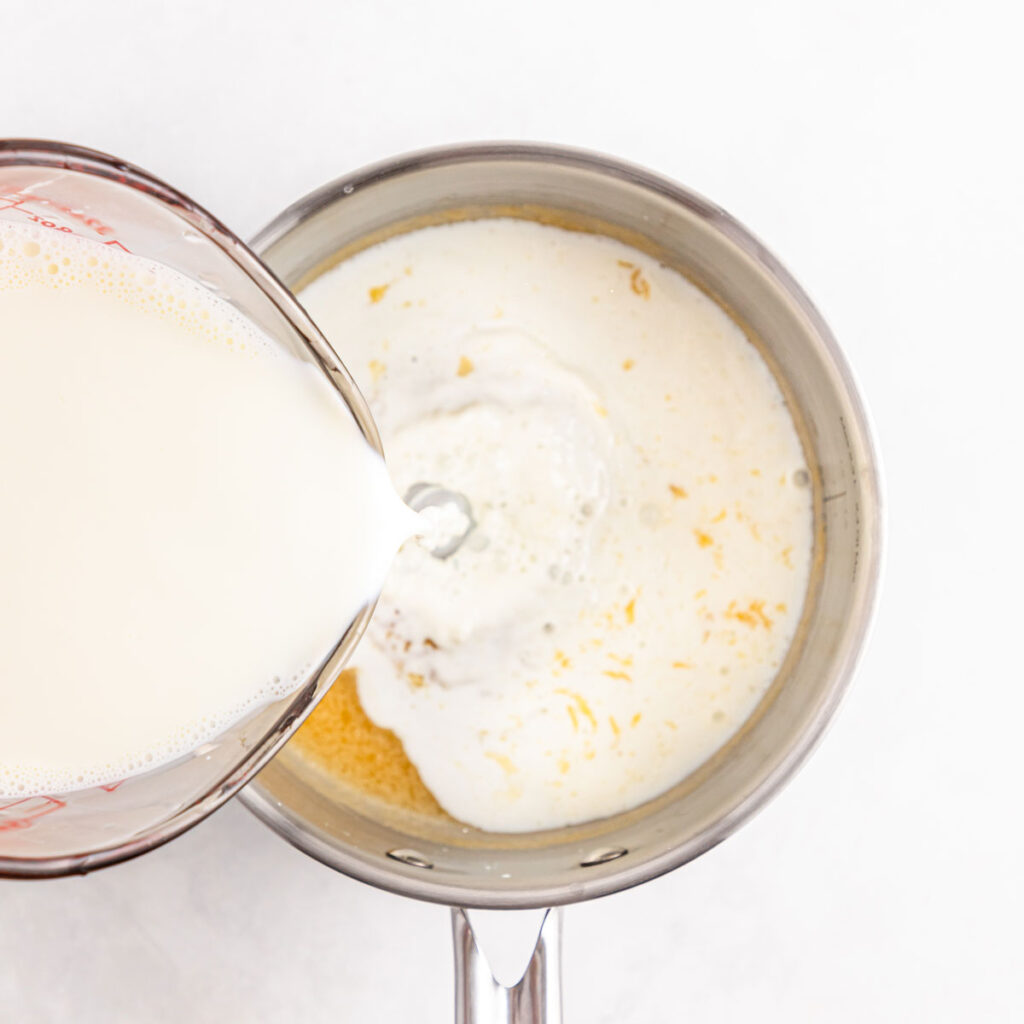 pouring milk into roux for bechamel sauce