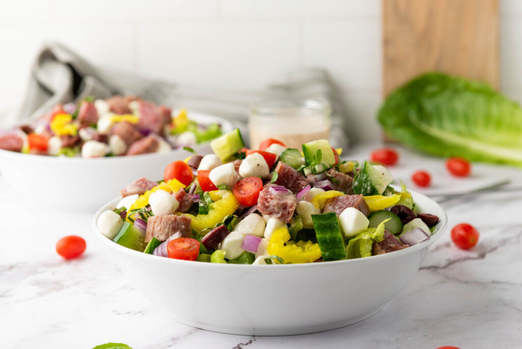 Italian chopped salad in white bowl on counter