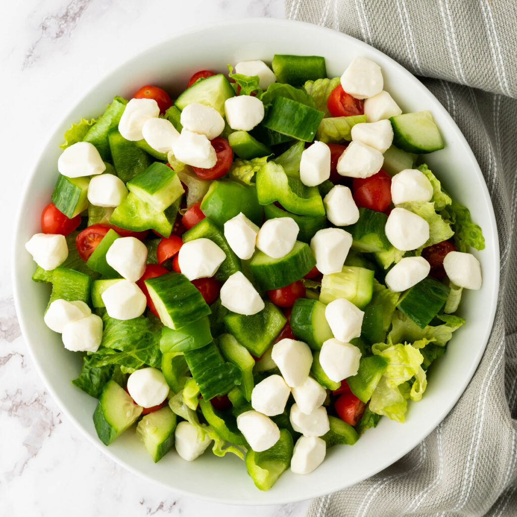 lettuce, tomatoes and mozzarella in bowl