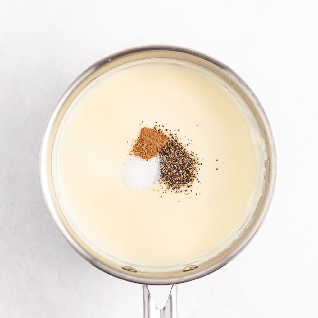 bechamel sauce with seasonings in pot