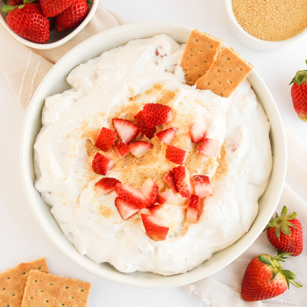 overhead view of strawberry cheesecake dip with graham crackers