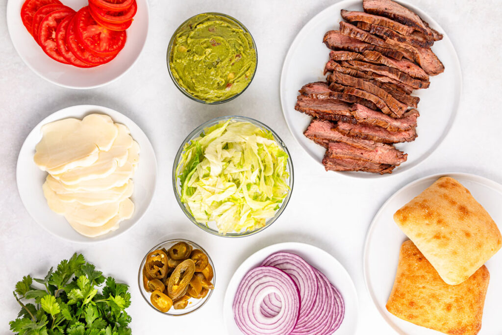 carne asada tortas ingredients in bowls on countertop