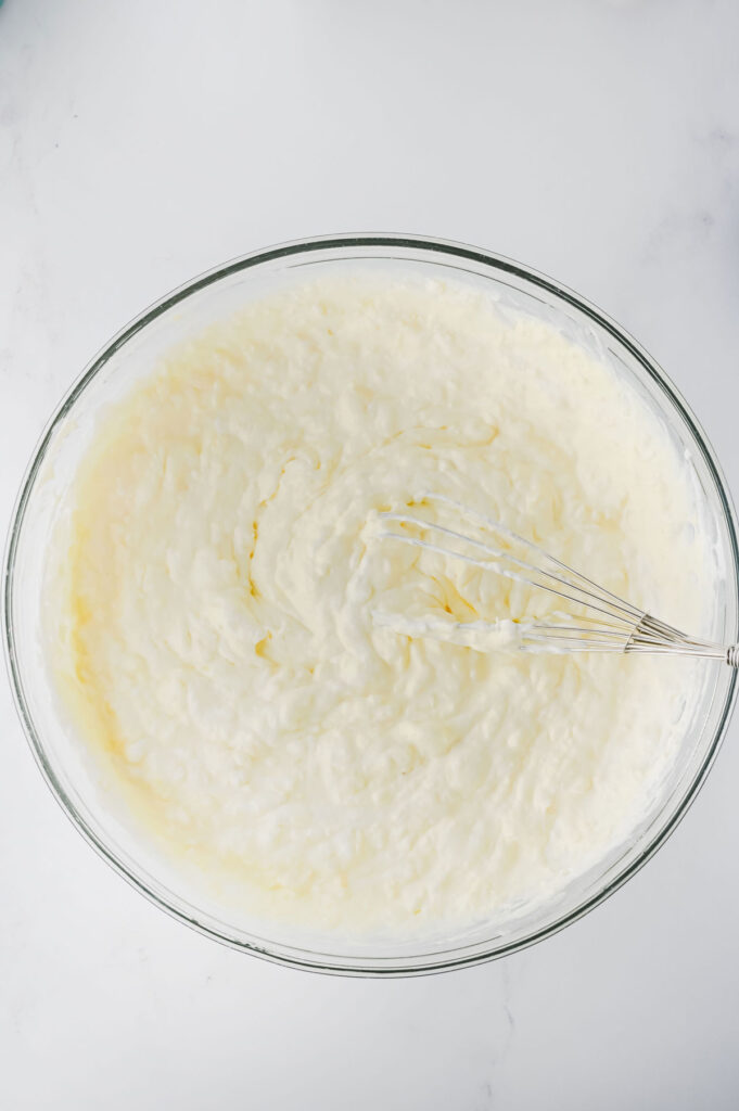 mixing cool whip for banana split fluff salad