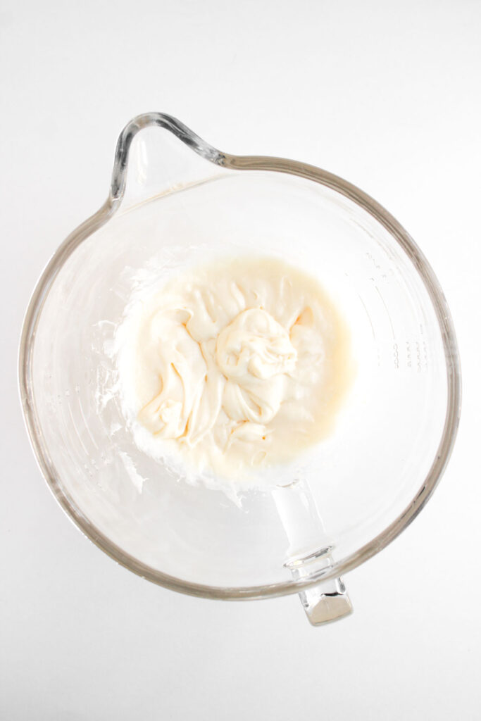 glass mixing bowl with whipped cheesecake filling