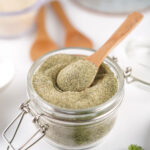 glass container of homemade ranch seasoning with wooden spoon