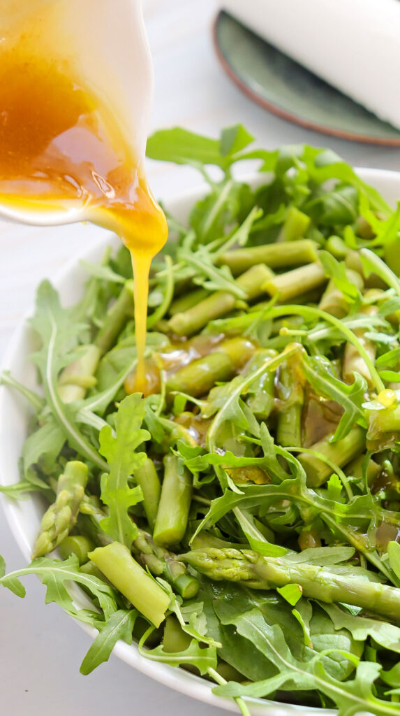 pouring dressing over salad