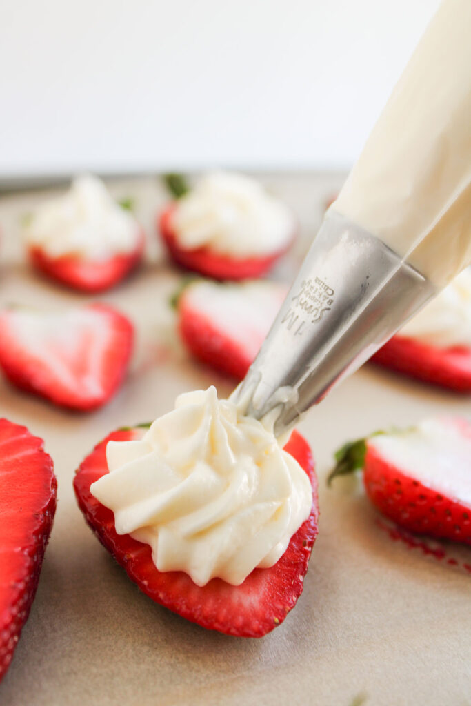 filling deviled strawberries with piping bag