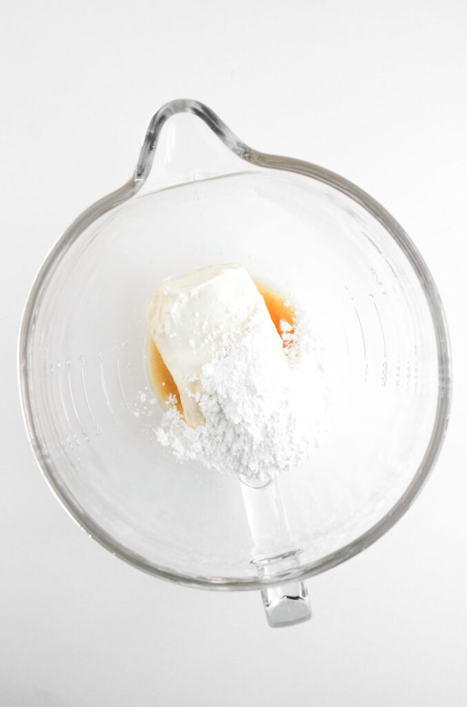 cheesecake filling ingredients in glass mixing bowl