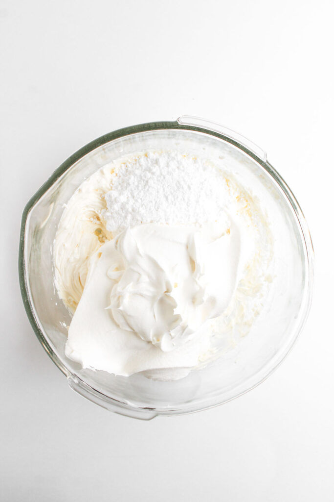 cool whip and whipped cream cheese in glass bowl