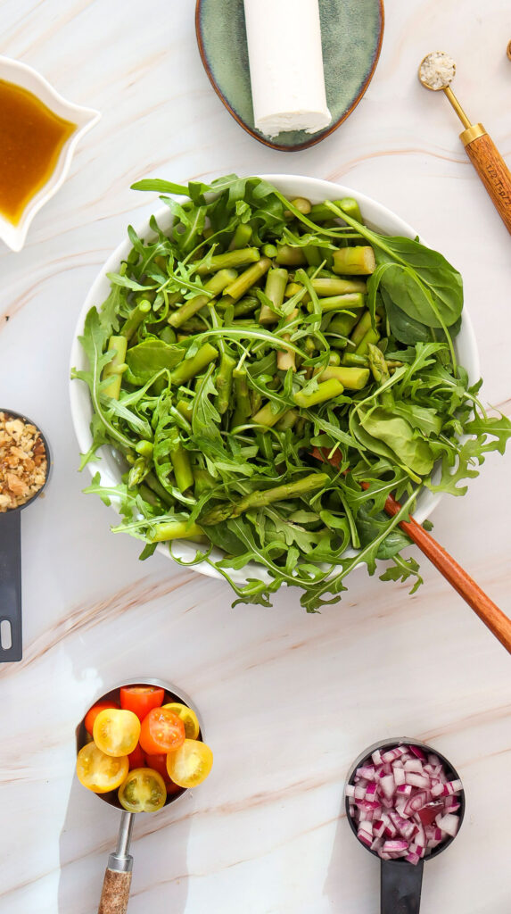 bowl of lettuce and chopped asparagus